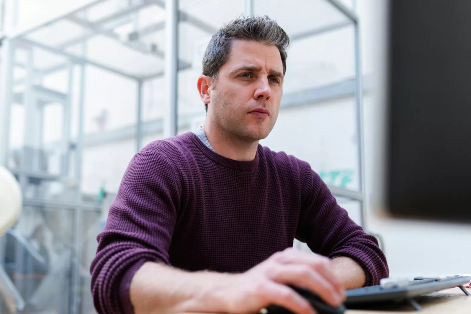 man in purple sweater working on engineering project